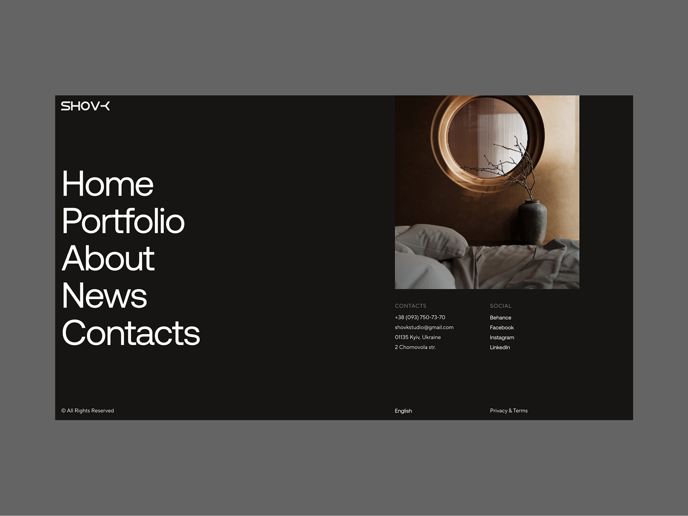 Website footer with navigation menu on black background, contact info, social links, and a round mirror above a bed with dried branches in a vase.